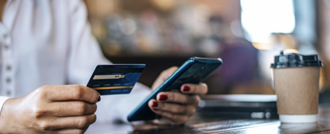 Image of a woman paying for her coffee.